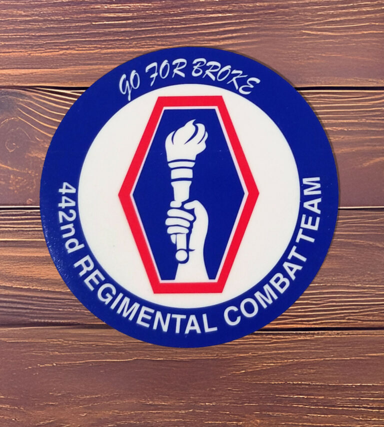 3 inch round adhesive back 442nd regiment logo sticker on a wood background