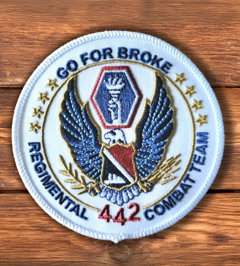 442nd Delta Queen round logo patch on a wood background