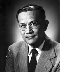 Hung Wai Ching - Black and white photo of man in glasses and suit looking at camera